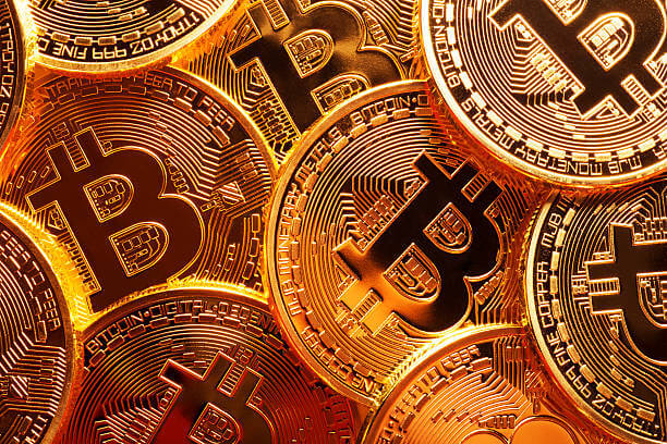 A close up photo of several gold plated bitcoins