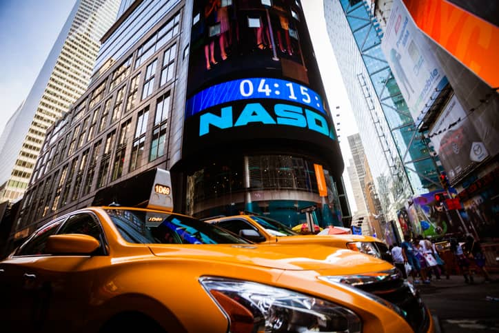 Yellow taxis under the Nasdaq Sign